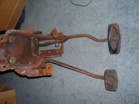 1979 Ford Bronco - Rusty clutch and brake pedal assembly, likely for a manual transmission vehicle.