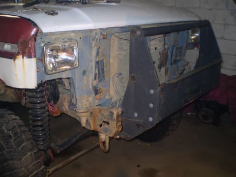 1986 Ford Bronco - The front end of a 1986 Ford Bronco shows signs of modification with an aftermarket bumper and exposed radiator, indicating ongoing work or…