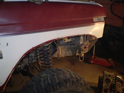 1986 Ford Bronco - Front fender removed from a 1986 Ford Bronco to access the suspension components.