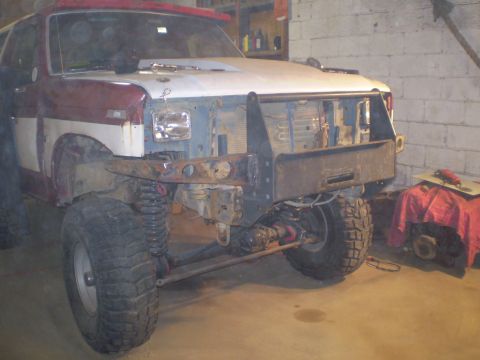1986 Ford Bronco - This lifted Ford Bronco is undergoing modifications, with its front end disassembled and an aftermarket bumper installed.