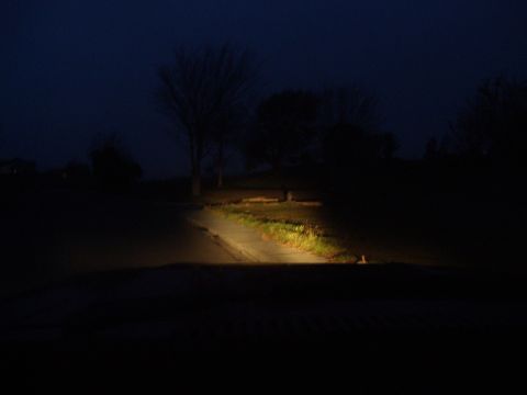 1986 Ford Bronco - Nighttime view from the driver's seat, showing the road ahead illuminated by headlights.