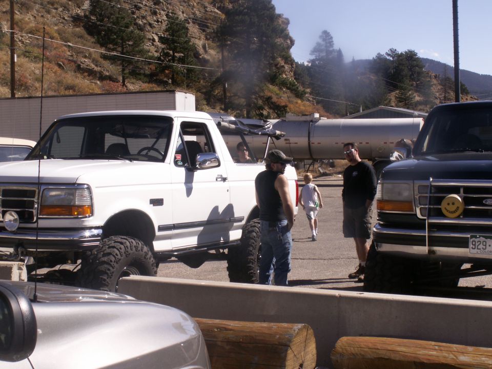 White Ford Bronco with large tires, 3/4 front view