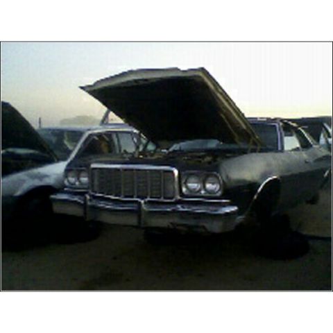 1973 Ford Ranchero - Junkyard scene with a 1973 Ford Ranchero and another vehicle, both with hoods open.