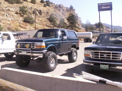 1986 Ford Bronco - This lifted 1992 Ford Bronco features large off-road tires and custom smiley face fog lights.
