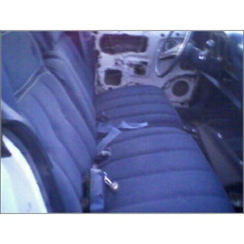 1973 Ford Ranchero - Interior of a car with a blue bench seat and exposed door panel.