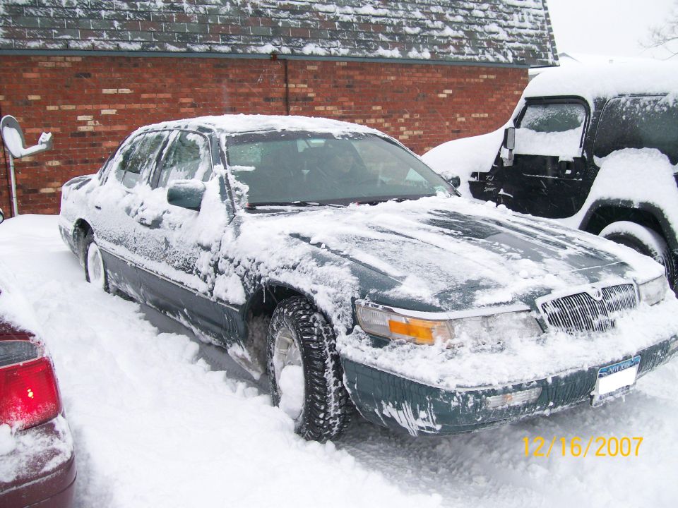 1995 Mercury Grand Marquis parked in snow, with another vehicle behind it