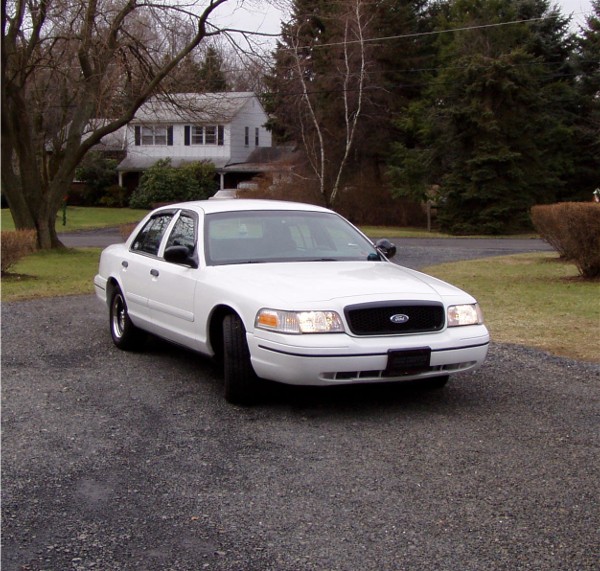 White 1999 Ford Crown Victoria parked in a driveway