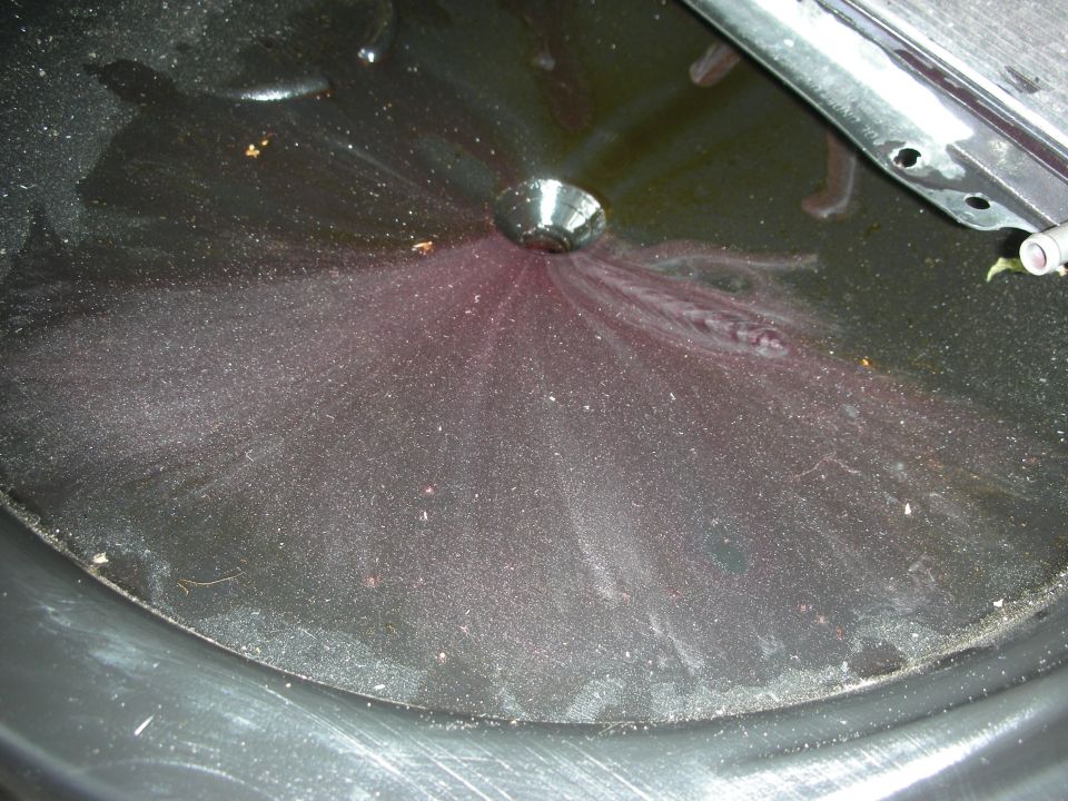 Transmission fluid pan with purple fluid and metal shavings