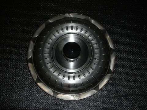 1992 Ford Crown Victoria - A metal torque converter, likely for an automatic transmission, is shown against a black textured background.