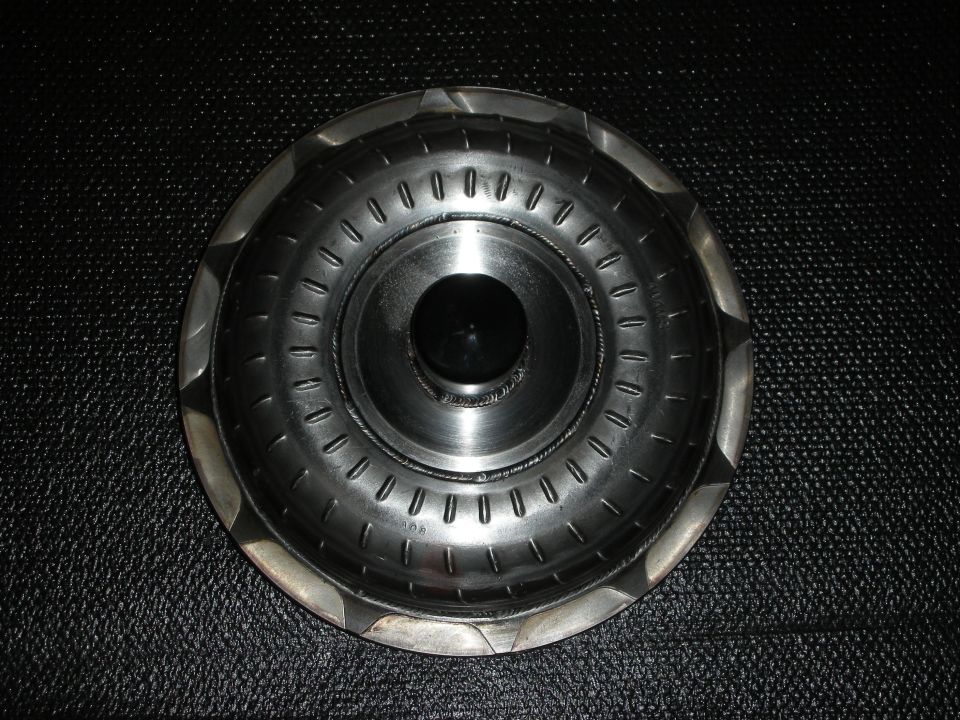 Torque converter with a black center hub and stamped metal fins
