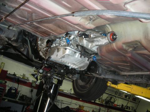 1992 Ford Crown Victoria - The underside of a vehicle is shown, focusing on the transmission and associated parts.