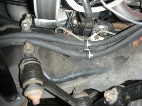 1992 Ford Crown Victoria - Close-up view of the underbody suspension system, showing various hoses, brackets, and mechanical linkages.
