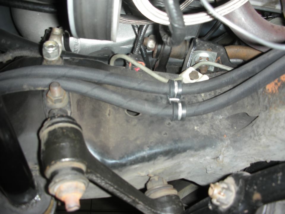 Underbody suspension components with hoses and brackets