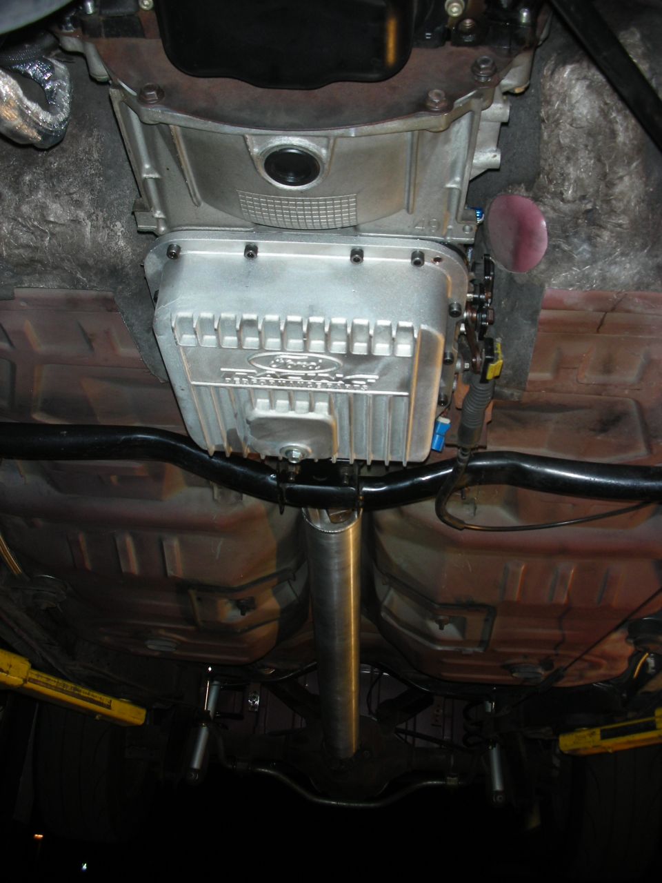 Close-up of a Ford transmission pan with fins and "Ford" logo visible