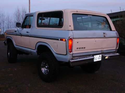 1978 Ford Bronco - Rear view of a 1978 Ford Bronco with a two-tone paint scheme and large tires.