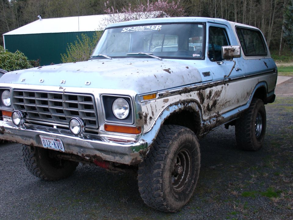 Muddy 1978 Ford Bronco with large tires parked outside