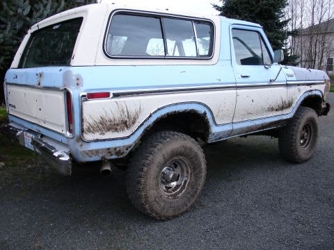 1978 Ford Bronco - This 1978 Ford Bronco is shown from a three-quarter front angle, heavily soiled with mud.