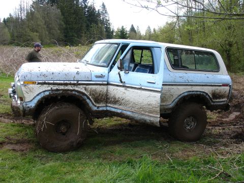 1978 Ford Bronco - This 1978 Ford Bronco is stuck deep in the mud, with its driver's door ajar.