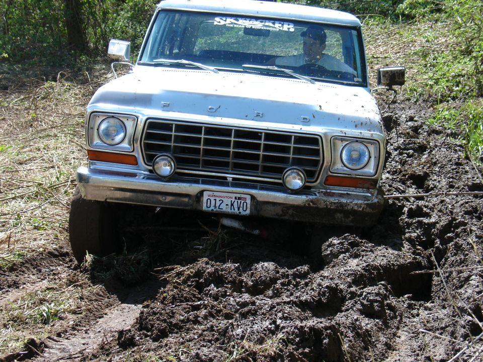 Silver 1978 Ford Bronco stuck in mud, front view
