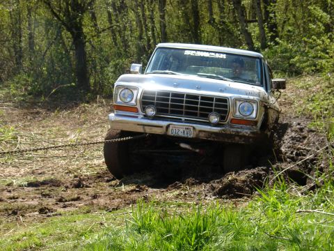 1978 Ford Bronco - This 1978 Ford Bronco is stuck deep in the mud, with a chain attached to its front.