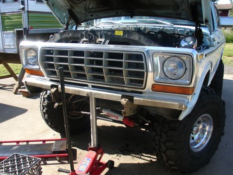 1978 Ford Bronco - Front view of a 1978 Ford Bronco with its hood open, showing the grille and modified suspension.
