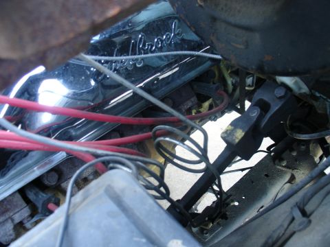 1978 Ford Bronco - Close-up view of an engine bay, showing a chrome valve cover and red spark plug wires.