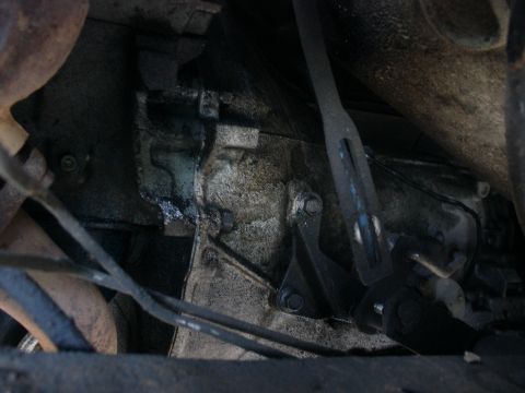 1978 Ford Bronco - Underside view of a vehicle's transmission and shift linkage, showing mechanical components.