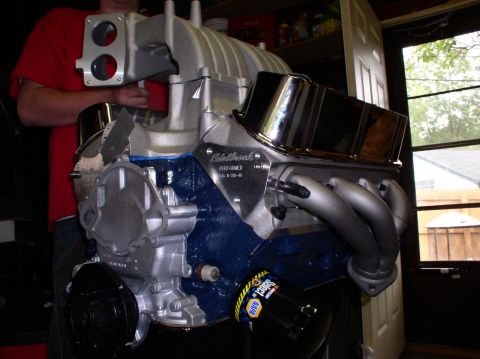 1993 Ford Bronco - Edelbrock Performer intake manifold and headers on a Ford V8 engine block.