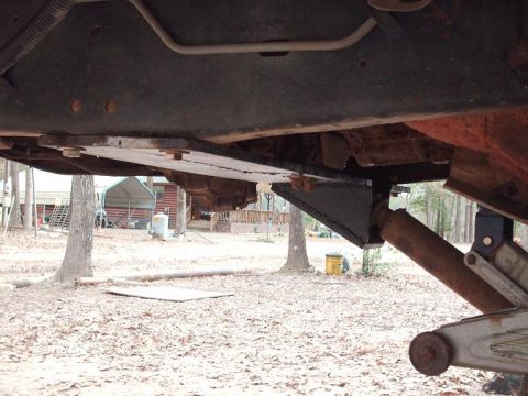 1990 Ford F-150 - A 1990 Ford F-150 undergoes a straight axle swap, evident from the custom brackets and modified suspension components visible underneath.