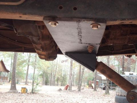 1990 Ford F-150 - Underside view of a custom suspension bracket modification on a truck frame, near the transmission housing.