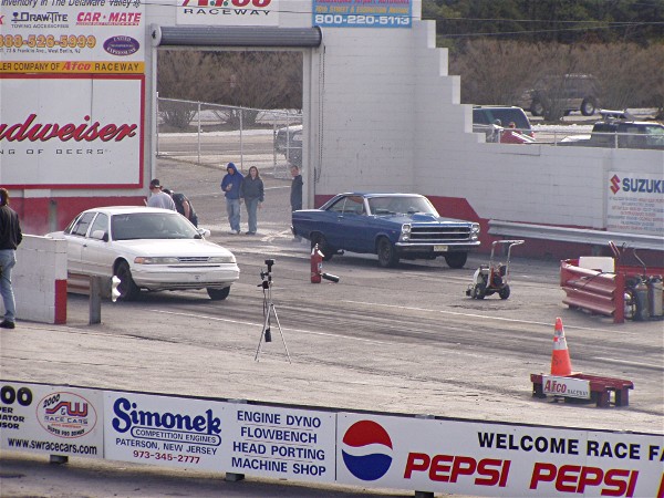 White sedan at a drag strip, front view