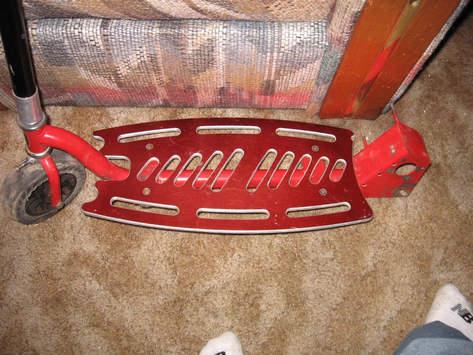red kick scooter deck and front wheel