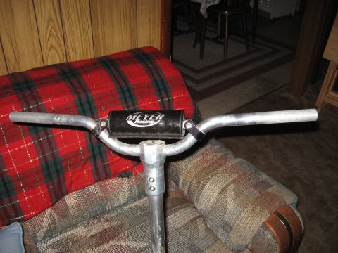 1992 Ford Crown Victoria - A close-up view of a handlebar with a 'Meyer Racing' logo, positioned indoors.
