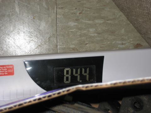 1981 Ford Bronco - A digital scale displays a weight of 84.4 pounds, with a portion of a cardboard box visible.