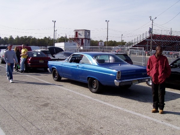 Blue 1966 Ford Fairlane coupe with black wheels and a lowered stance