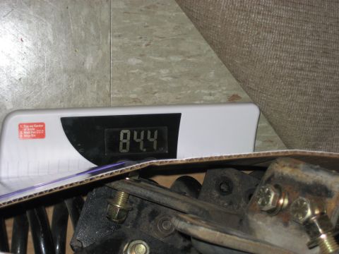 1981 Ford Bronco - A close-up shows vehicle parts being weighed on a digital scale, which reads 84.4.