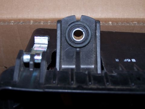 1995 Ford Probe - Close-up of a black plastic automotive part, possibly from the 'Evo Parts' section, a rubber grommet and metal mounting clips.