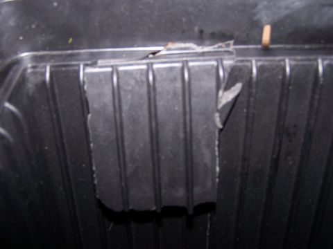 1995 Ford Probe - Close-up view of a damaged air filter housing with torn insulation material.