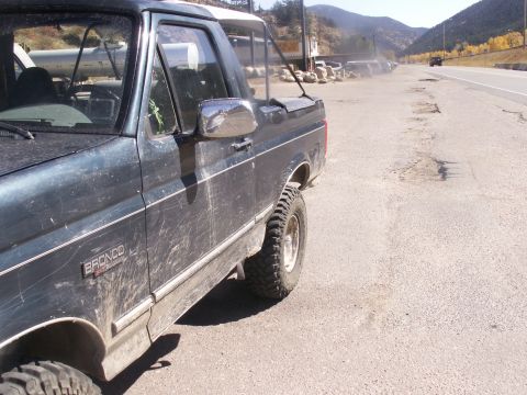 1986 Ford Bronco - This 1986 Ford Bronco is seen parked on the side of a road, with its 'Bronco' badge clearly visible.