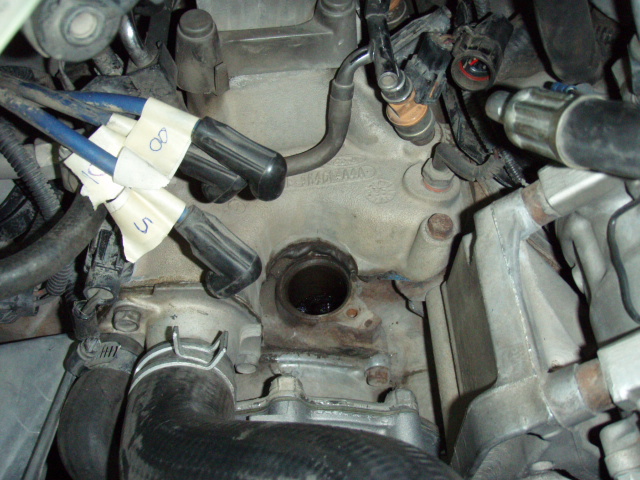 Engine part with numbered spark plug wires
