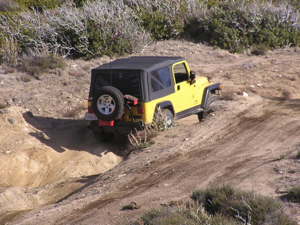 Yellow Jeep climbed hill