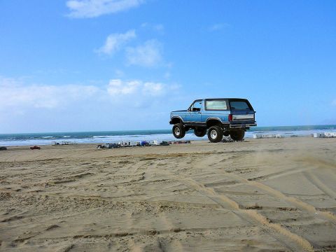 1984 Ford Bronco - Ford Bronco airborne on a beach.