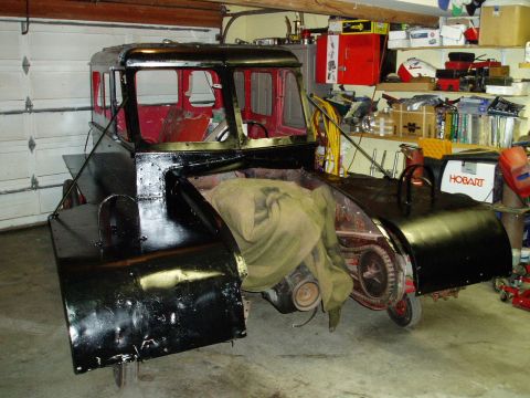 2000 Ford E350 - Custom vehicle project in a garage, with engine exposed and bodywork in progress.