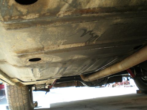 1966 Ford Mustang - The underside of a vehicle is visible, with focus on the exhaust system and rear axle components.