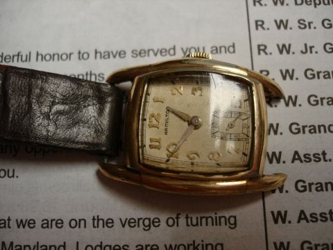 1994 Ford Bronco - A close-up of a vintage Hamilton watch with a leather band rests on a document.