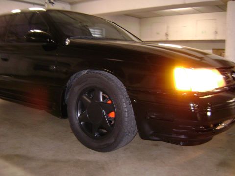 1991 Ford Taurus - Front corner view of a black 1991 Ford Taurus sedan.