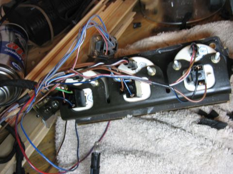 1987 Volkswagen Scirocco - Disconnected wiring harness and instrument cluster gauges on a workbench.