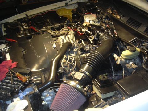 1997 Ford Crown Victoria - Aftermarket air filter installed in the engine bay, with tools laid out for work.