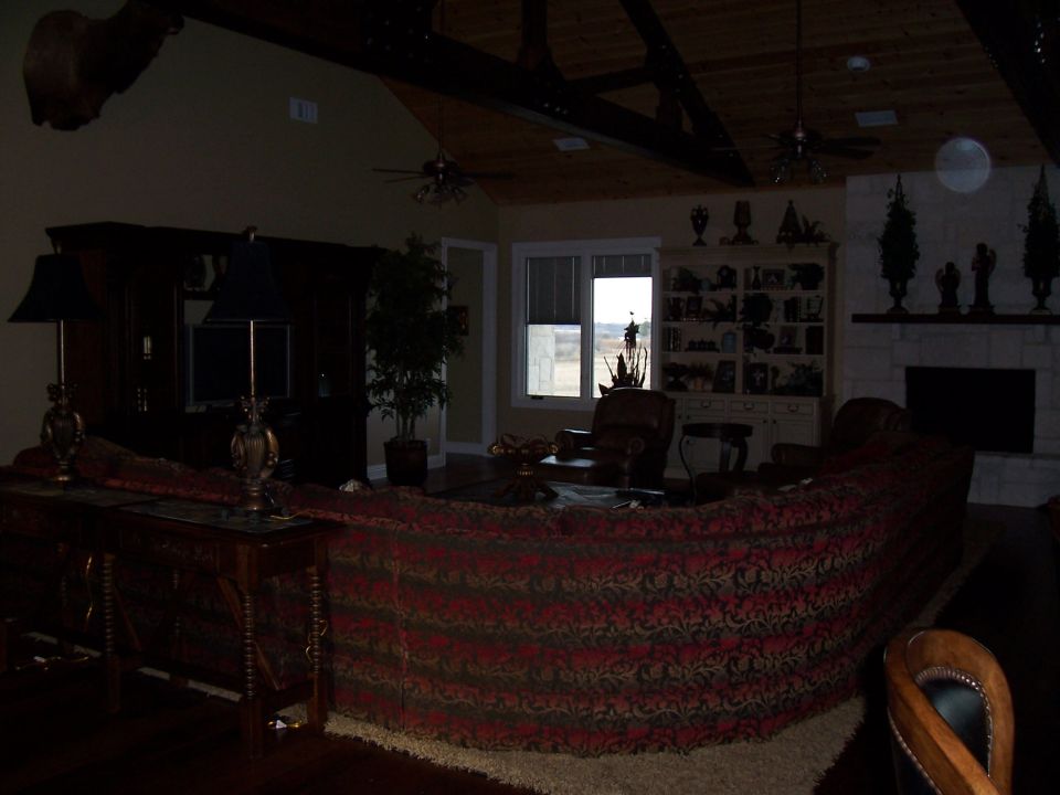 Living room with large sectional sofa, fireplace, and mounted animal head
