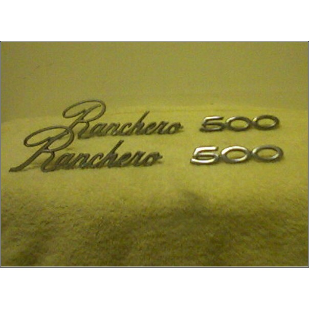 Two Ranchero emblems and two 500 emblems on a fuzzy surface